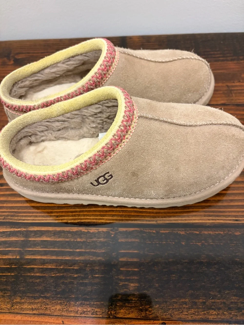 UGG Kids Slip-On Suede Slippers in Tan with Pink Trim